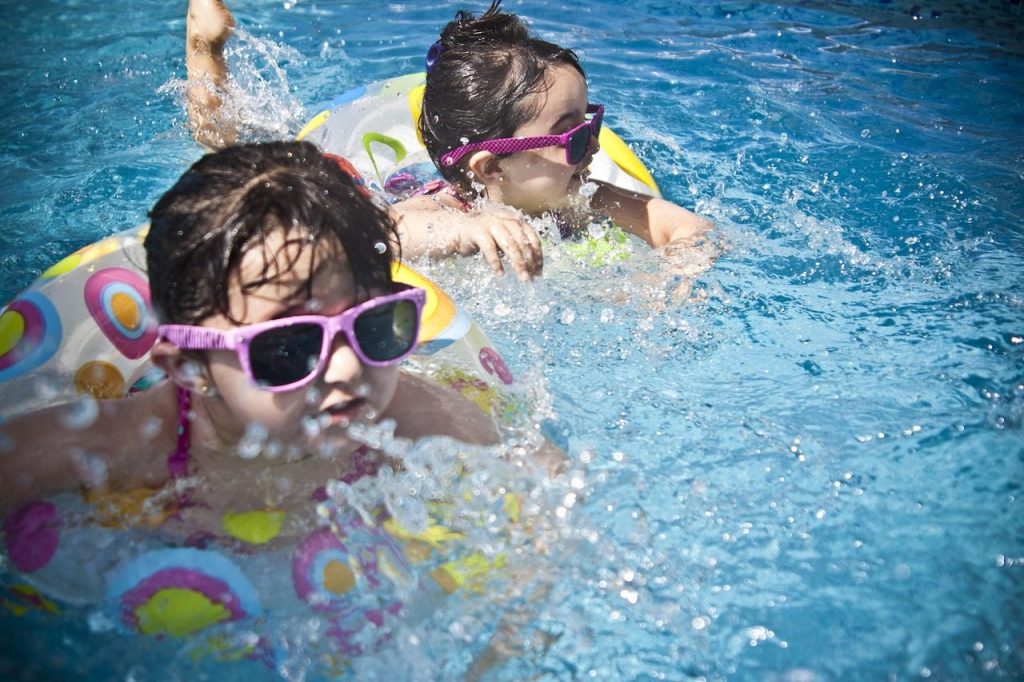 girls, swimming, splashing, sisters, little girls, floaters, nature, swim, swimming pool, pool, summer, vacation, splashing water, childhood, children, kids, shades, sunglasses, people, water, cute, wet, young, happy, joy, fun, activity, happiness