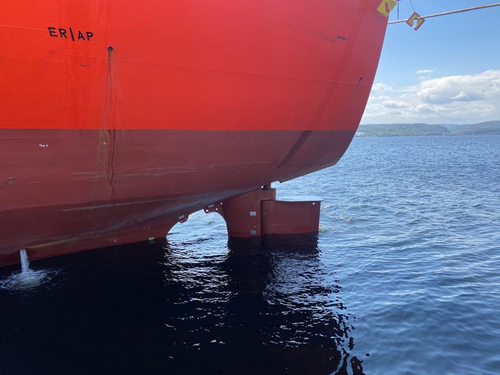 a large red boat sitting on top of a body of water