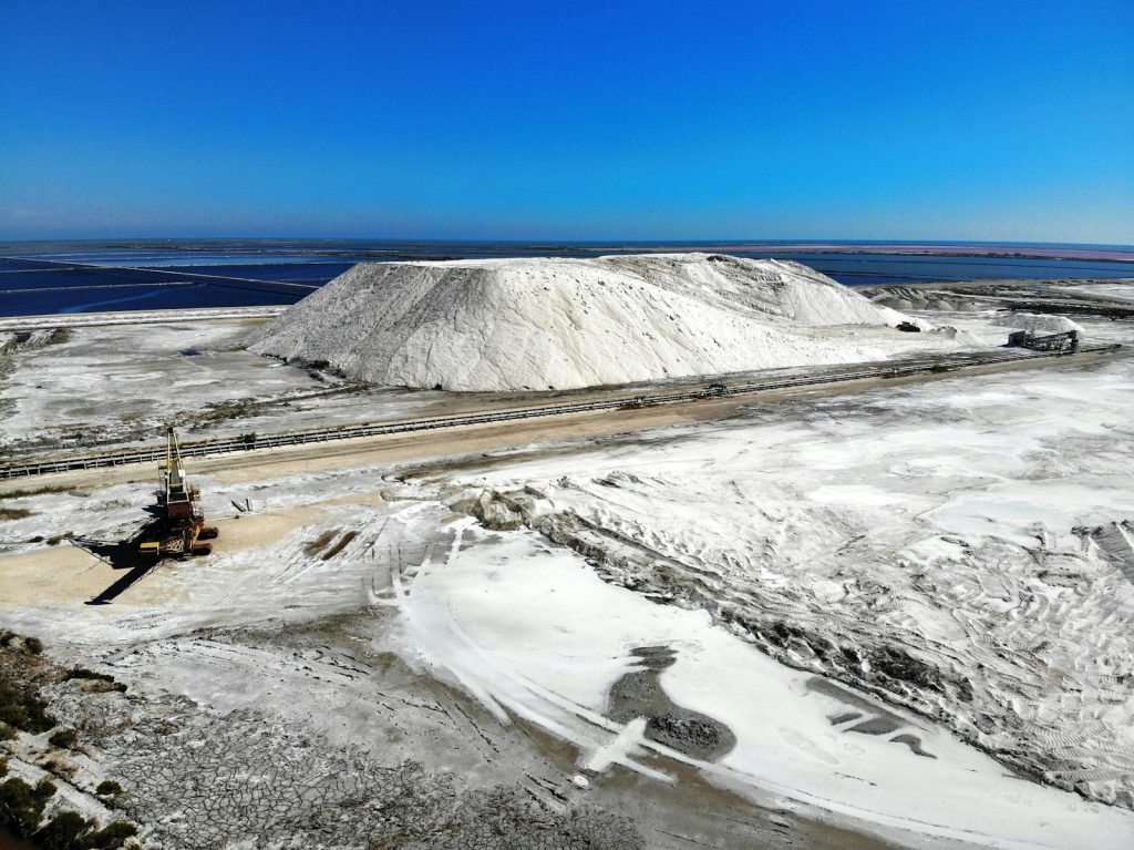 a large pile of snow next to a road