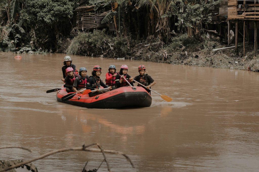 a group of people riding on the back of a raft down a river