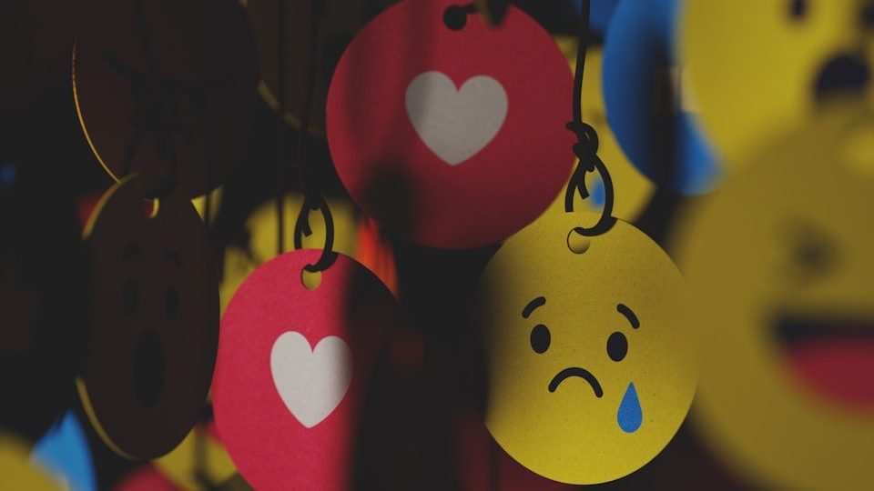 a bunch of smiley faces hanging from strings