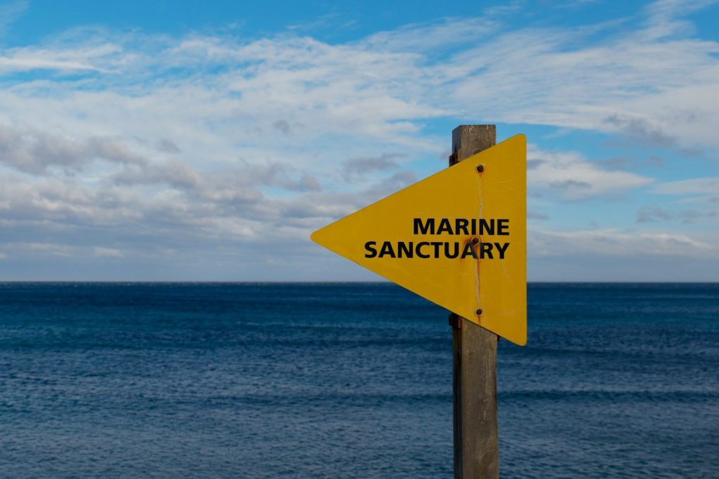 Sign indicates a marine sanctuary near the ocean.