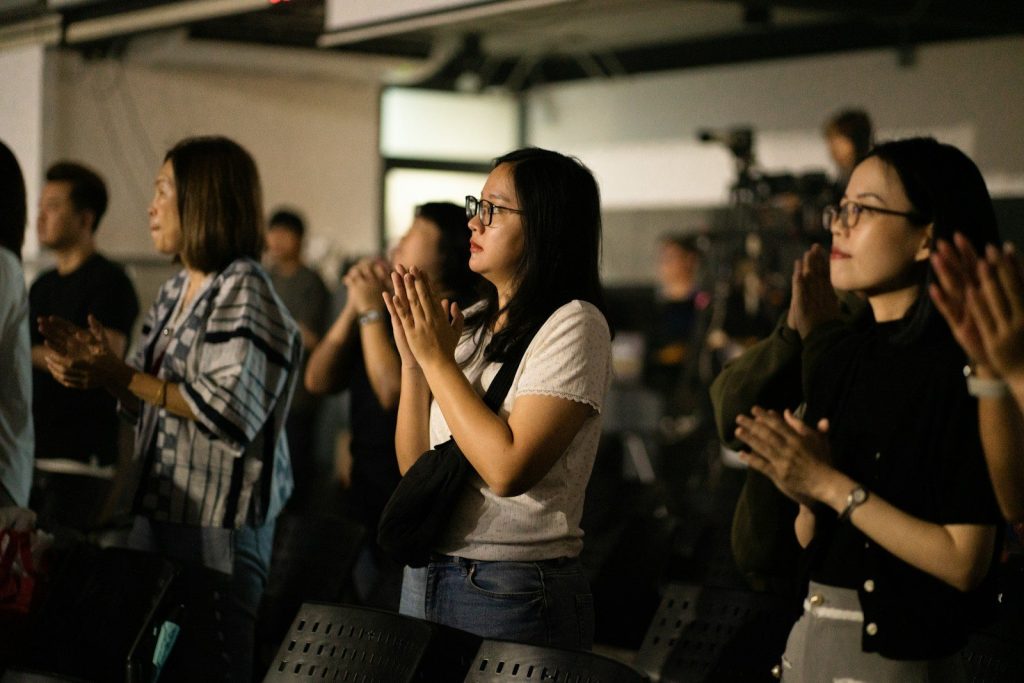 People clapping and watching an event