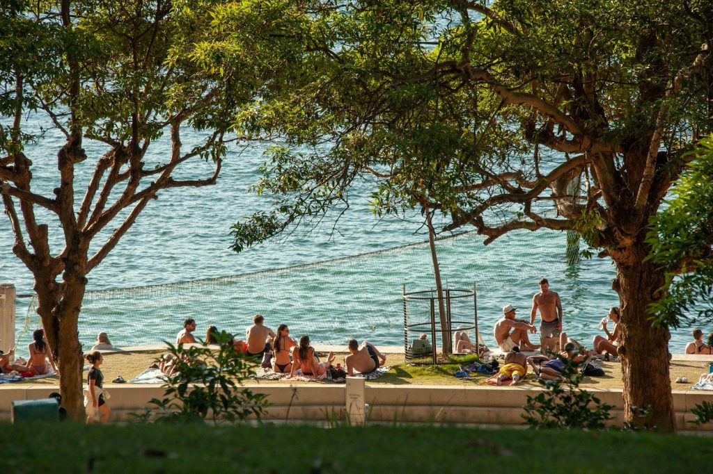 People relaxing on a sunny beach by the water