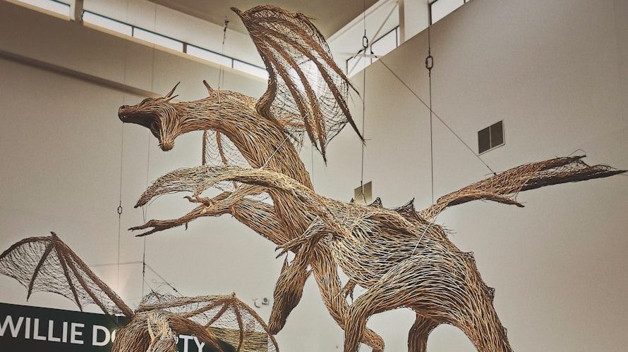 a sculpture of a flying bird in a museum