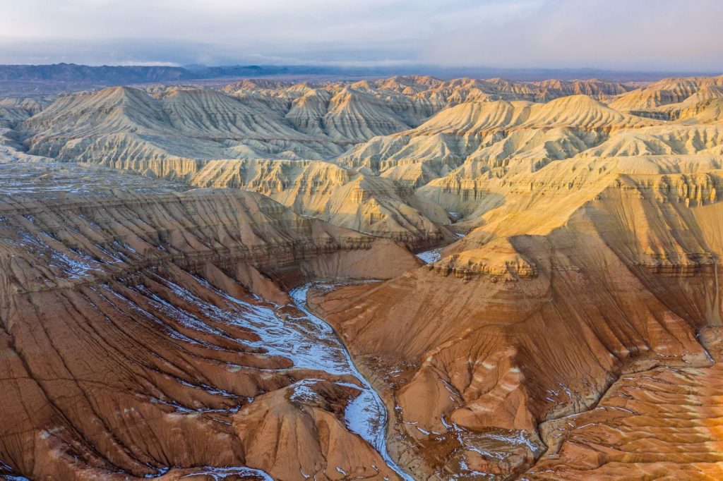 Explore the breathtaking landscape of Almaty's eroded canyons captured in a stunning aerial view.