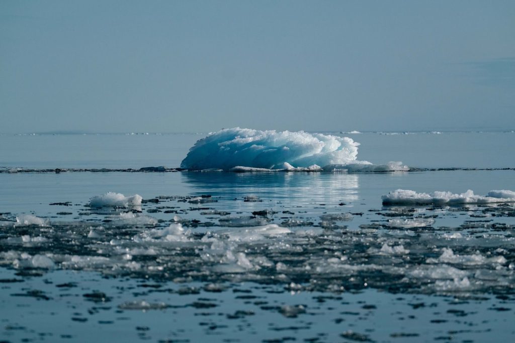 A serene view of a melting iceberg in the Arctic, symbolizing climate change impact.