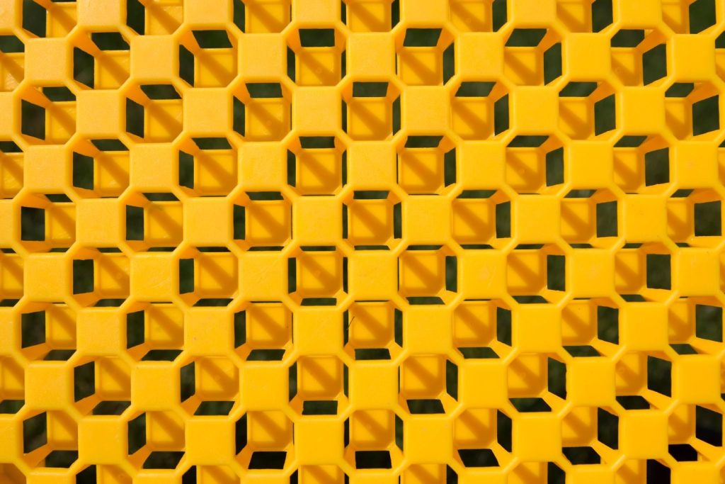 Vibrant yellow geometric pattern featuring repetitive cube shapes creates a striking visual effect.