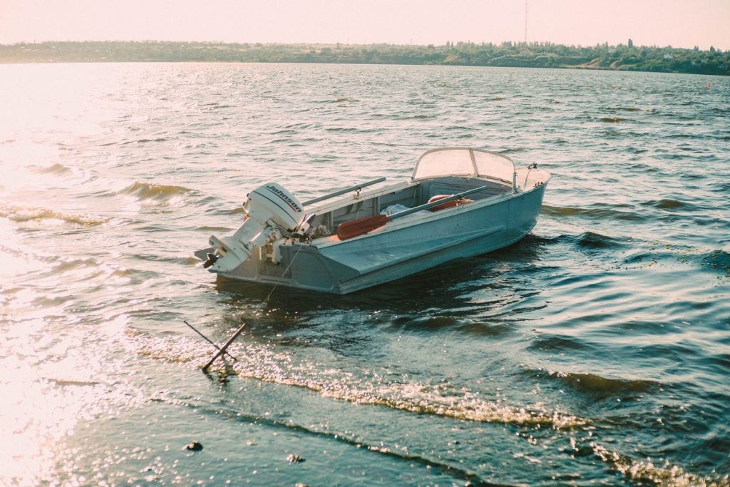 A solitary motorboat floating on a sunlit body of water, capturing serenity.