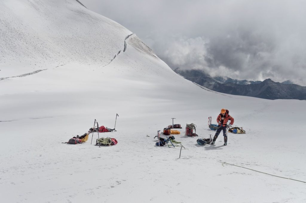 A climber prepares for a high-altitude expedition in the snowy Andes, La Paz, Bolivia.