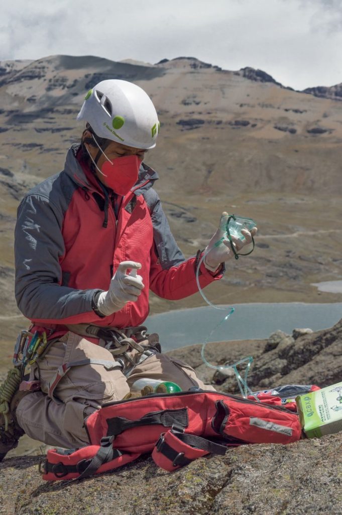 Mountaineer in La Paz, Bolivia sets up oxygen mask for high altitude climb.