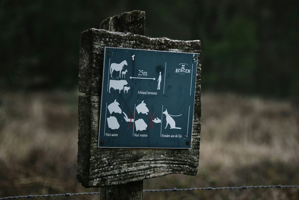 Sign with animal and dog-related instructions.