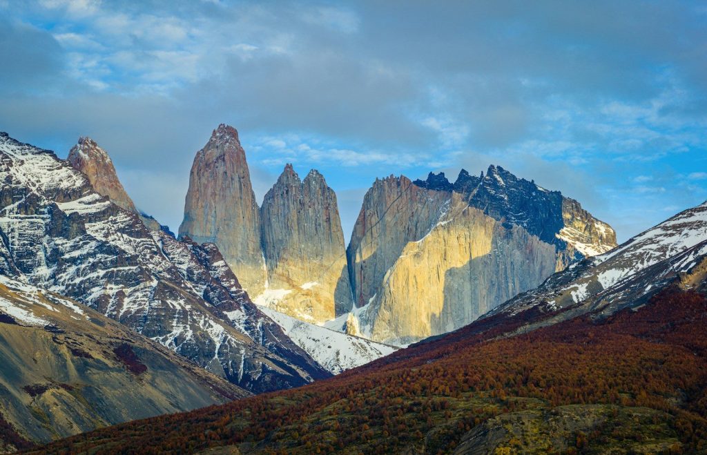 brown and white mountains under white clouds during daytime